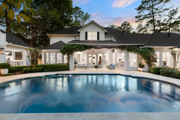 a view of a white house with a swimming pool