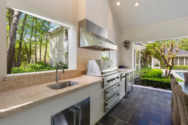 a kitchen with a sink and a large window