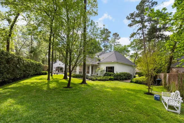 a house with a big yard and large trees