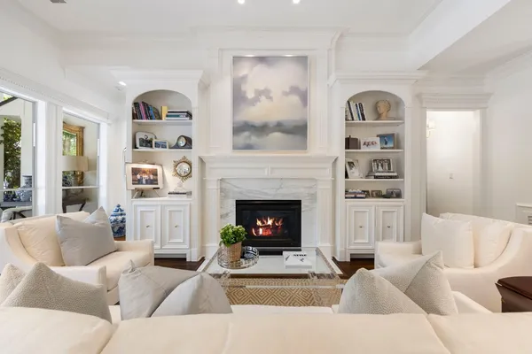 a living room with furniture a fireplace and a window
