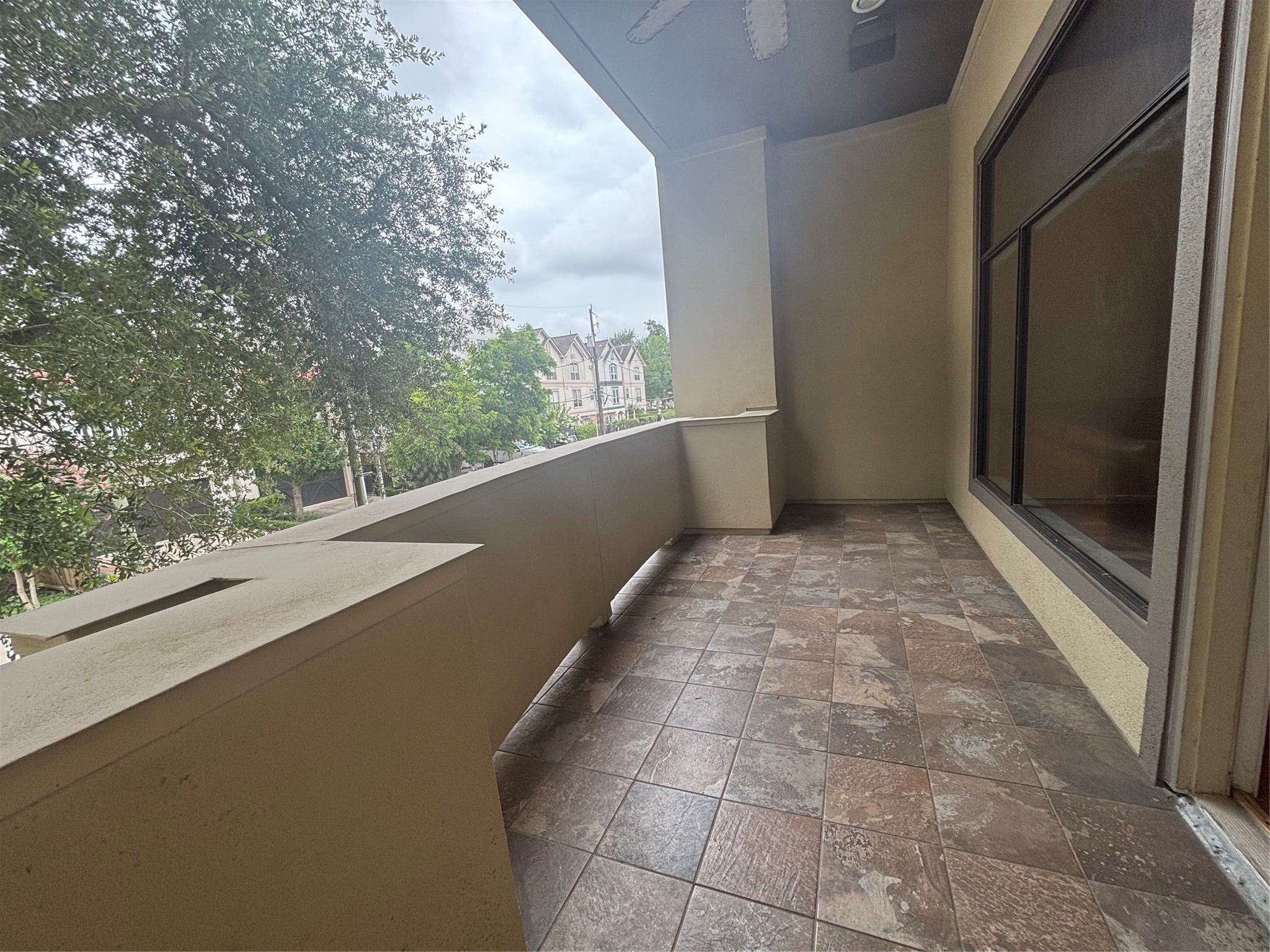 6016 Truro Street Houston, TX 77007 - Photo 8 of 26 Private second-floor balcony accessed directly from the living room, offering a perfect outdoor retreat for morning coffee, dining, or relaxing among the treetops