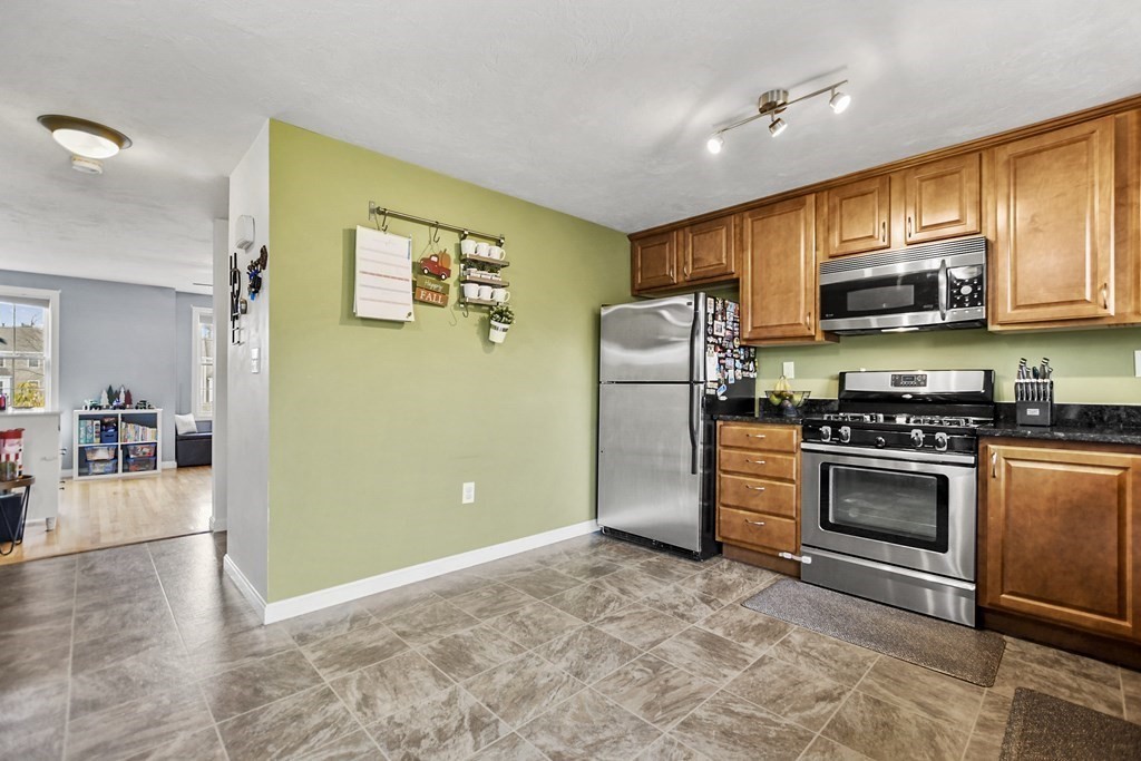 41 Boston Road, Unit 111 Billerica, MA 01862 - Photo 11 of 28 a kitchen with stainless steel appliances granite countertop a refrigerator stove and sink
