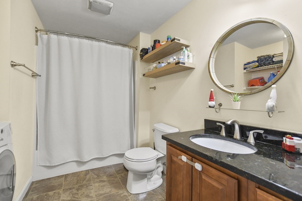 41 Boston Road, Unit 111 Billerica, MA 01862 - Photo 17 of 28 a bathroom with a granite countertop sink and a mirror