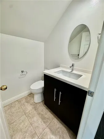 a bathroom with a sink vanity mirror and toilet
