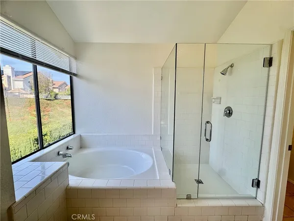 a bathroom with a bathtub and a shower
