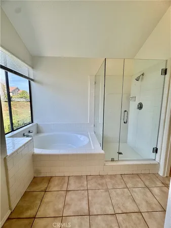 a bathroom with a tub shower and a sink