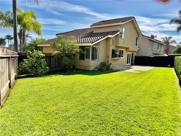 a view of a house with a yard patio and swimming pool
