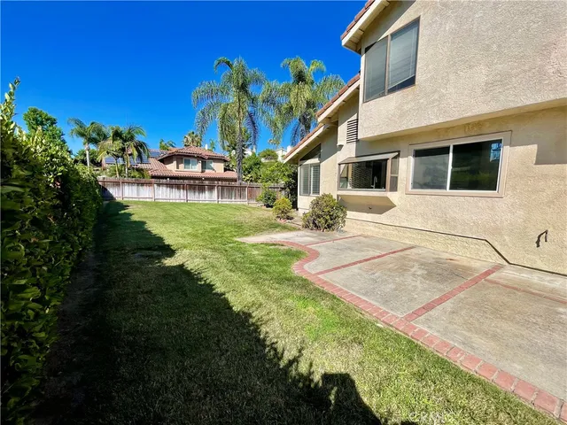 a view of a house with a backyard