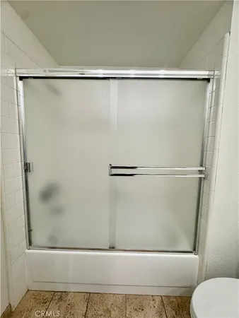 a bathroom with a shower and a toilet