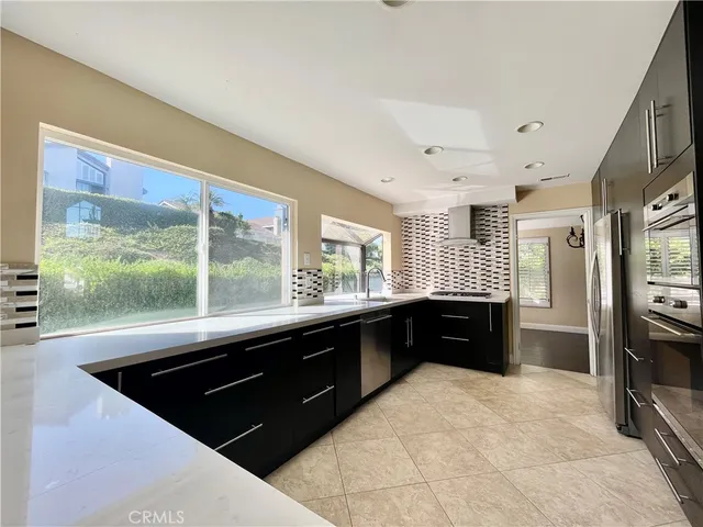 a kitchen with a sink stove and refrigerator