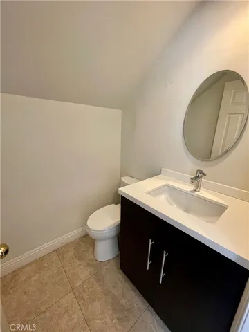 a bathroom with a sink toilet and a mirror