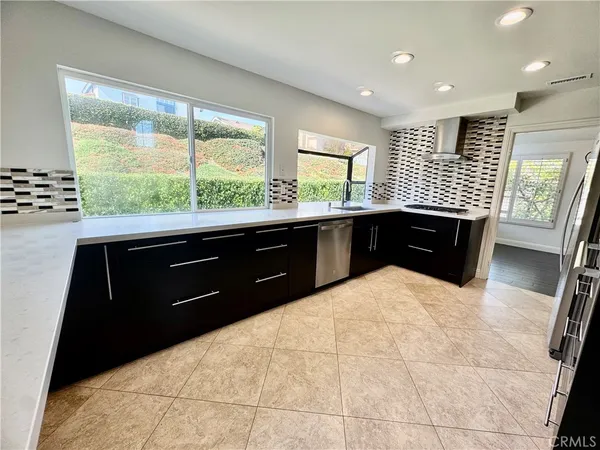 a kitchen with a sink and wooden cabinets