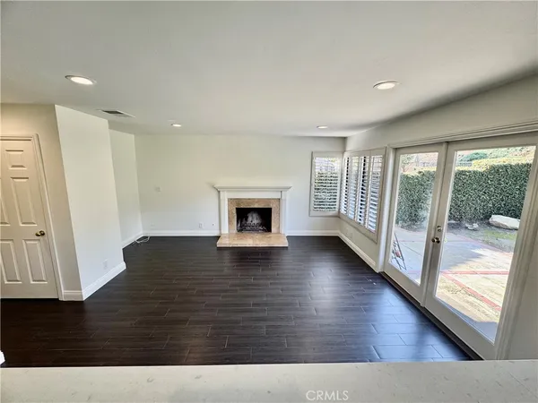 wooden floor in an empty room with a fireplace