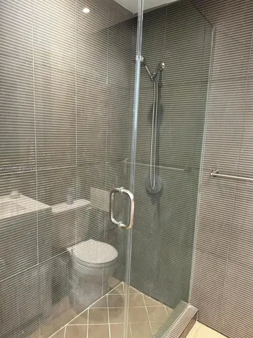 a bathroom with a toilet and a shower