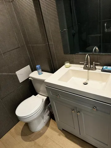 a white toilet sitting next to a bathroom sink