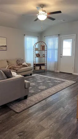 a kitchen with a table chairs and a wooden floor