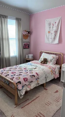 a bedroom with a bed and dresser