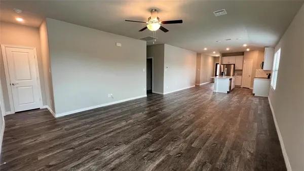 a view of an empty room and wooden floor