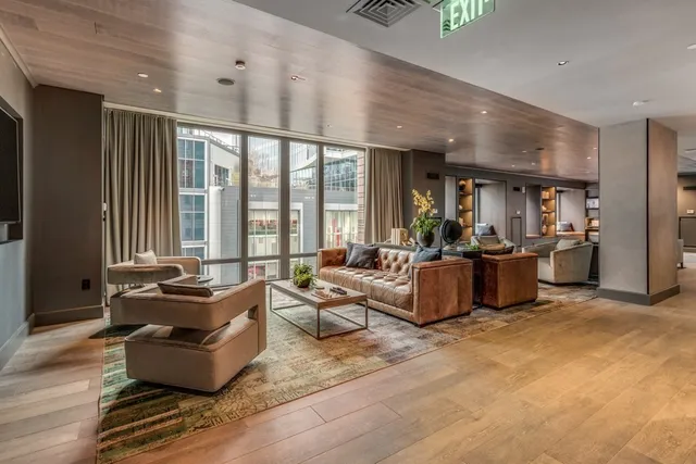 a living room with furniture and large windows