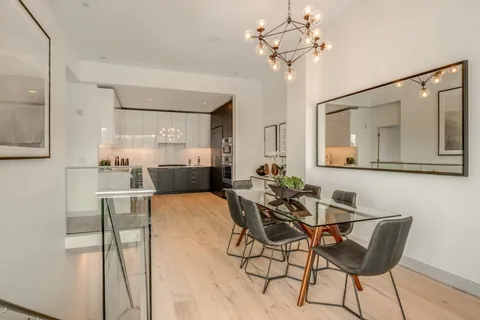 a view of a dining room with furniture and a chandelier