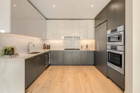 a kitchen with stainless steel appliances a refrigerator sink and stove