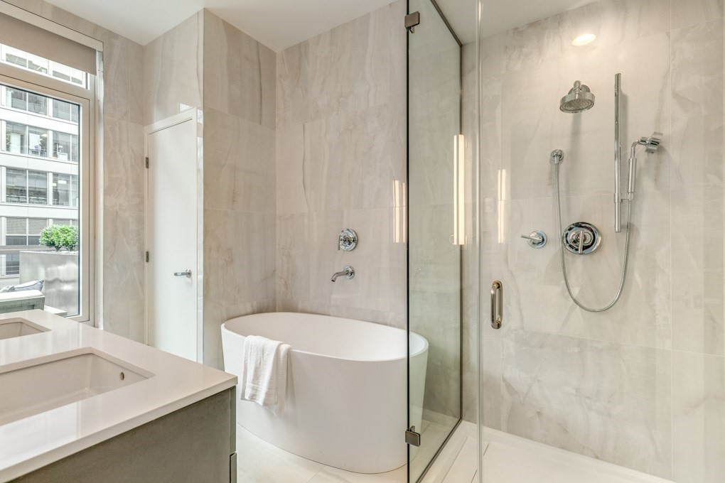 1350 Boylston Street, Unit L415 Boston, MA 02215 - Photo 7 of 16 a bathroom with a granite countertop sink a mirror and a shower