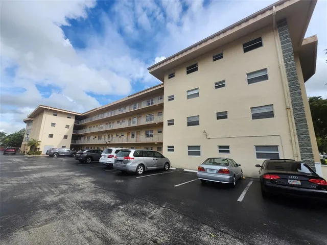 a backyard of a house with lots of green space and fountain
