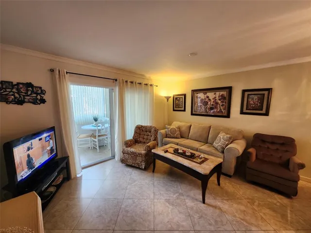 a kitchen with white cabinets and black appliances