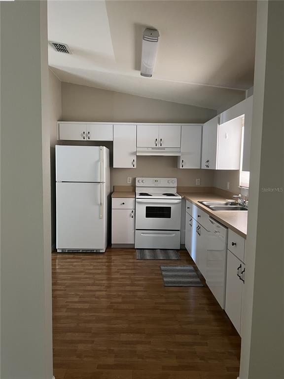 6035 Southwest 98th Street Road Ocala, FL 34476 - Photo 15 of 15 a kitchen with a refrigerator stove and white cabinets