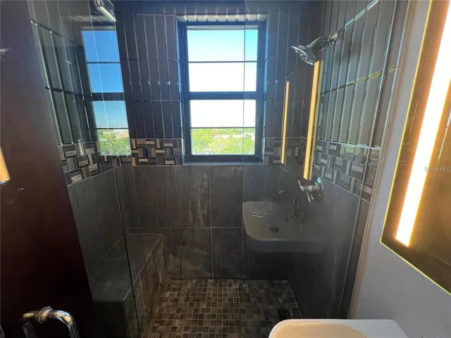 a bathroom with a sink toilet and window