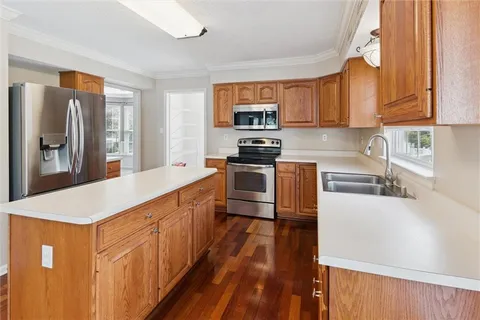 a kitchen with stainless steel appliances a sink and a refrigerator