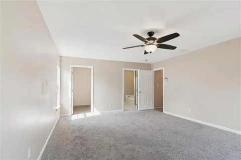 a view of a room with a ceiling fan and a window