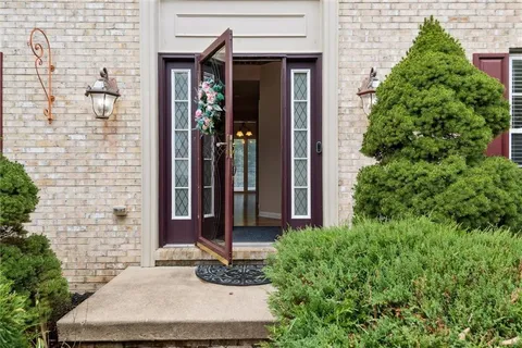 a view of a house with potted plants