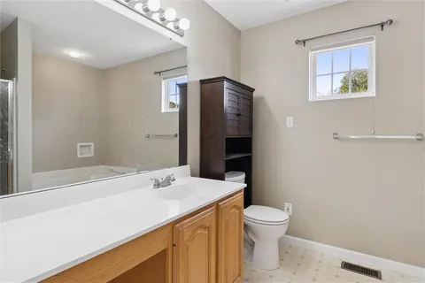 a white bath tub sitting next to a white wall