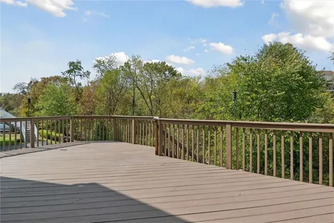 a balcony with wooden floor and fence