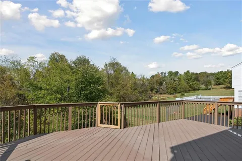 a balcony with wooden floor and fence