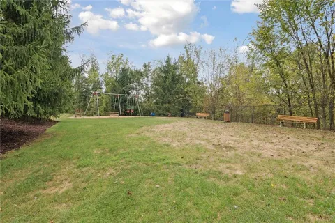 an aerial view of residential houses with outdoor space and parking
