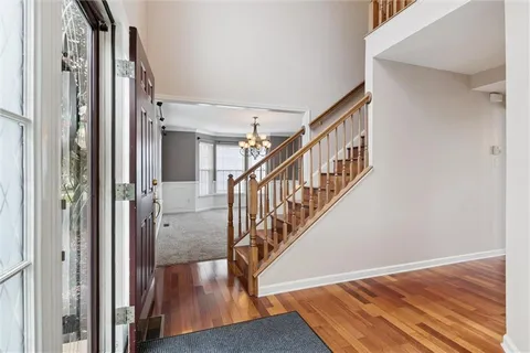 a view of entryway and hall with wooden floor