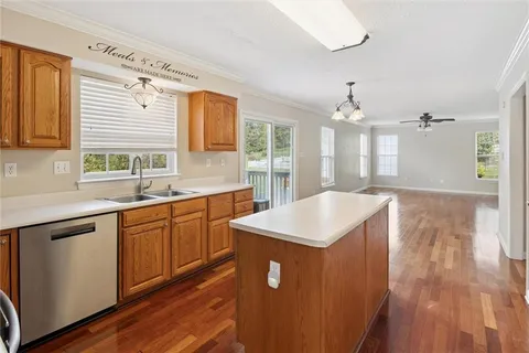 a kitchen with sink cabinets and wooden floor