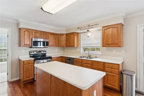 a kitchen with a sink a stove and cabinets
