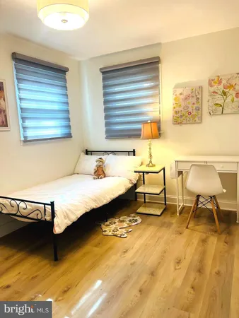 a spacious bedroom with a bed and a table in it