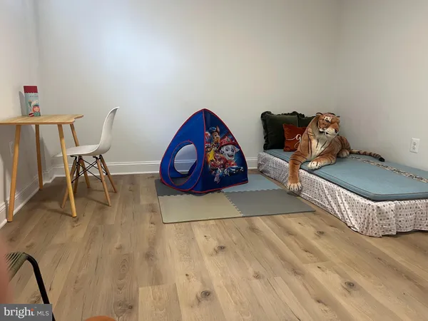 a view of a house with a yard and potted plants