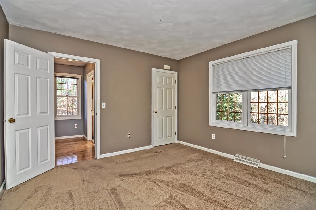 43 Stall Brook Road, Unit 43 Milford, MA 01757 - Photo 11 of 27 a view of an empty room with wooden floor and a window
