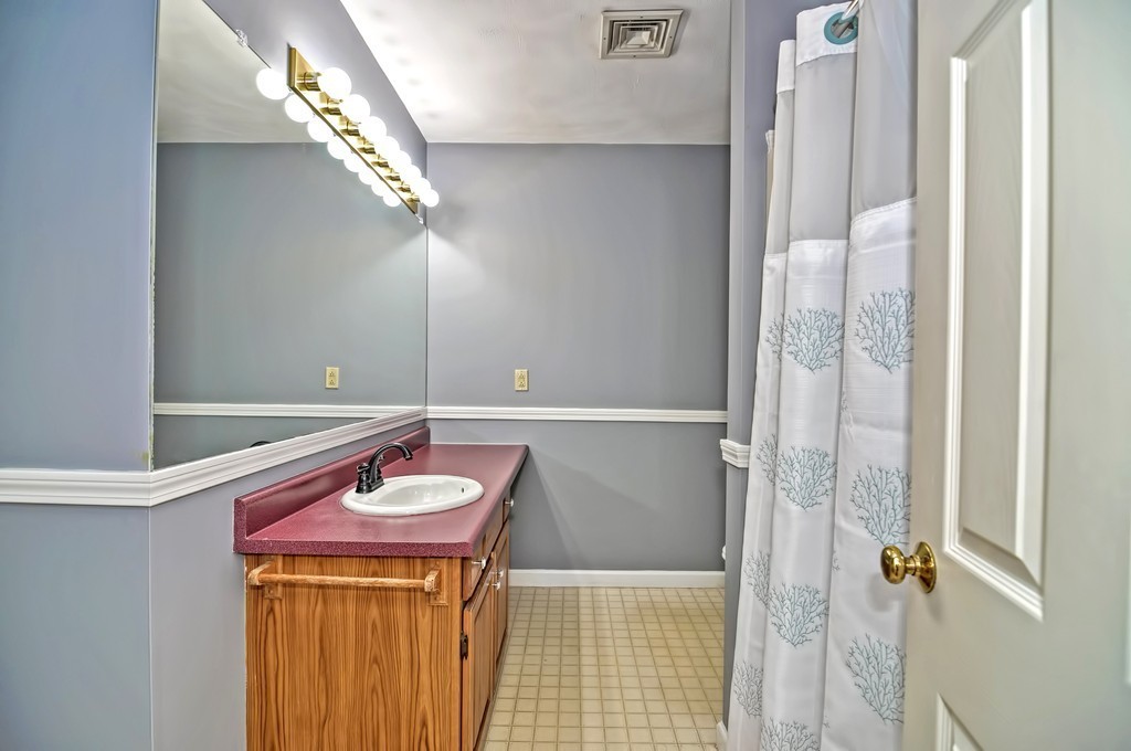 43 Stall Brook Road, Unit 43 Milford, MA 01757 - Photo 19 of 27 a bathroom with a sink and a mirror