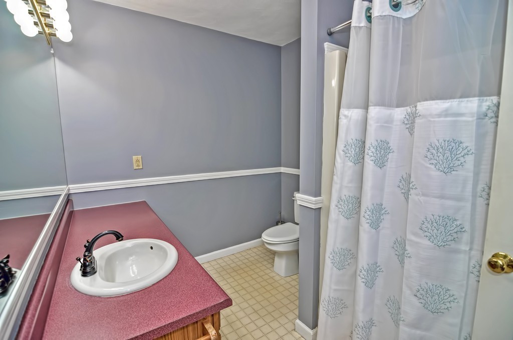 43 Stall Brook Road, Unit 43 Milford, MA 01757 - Photo 20 of 27 a bathroom with a toilet a sink and vanity