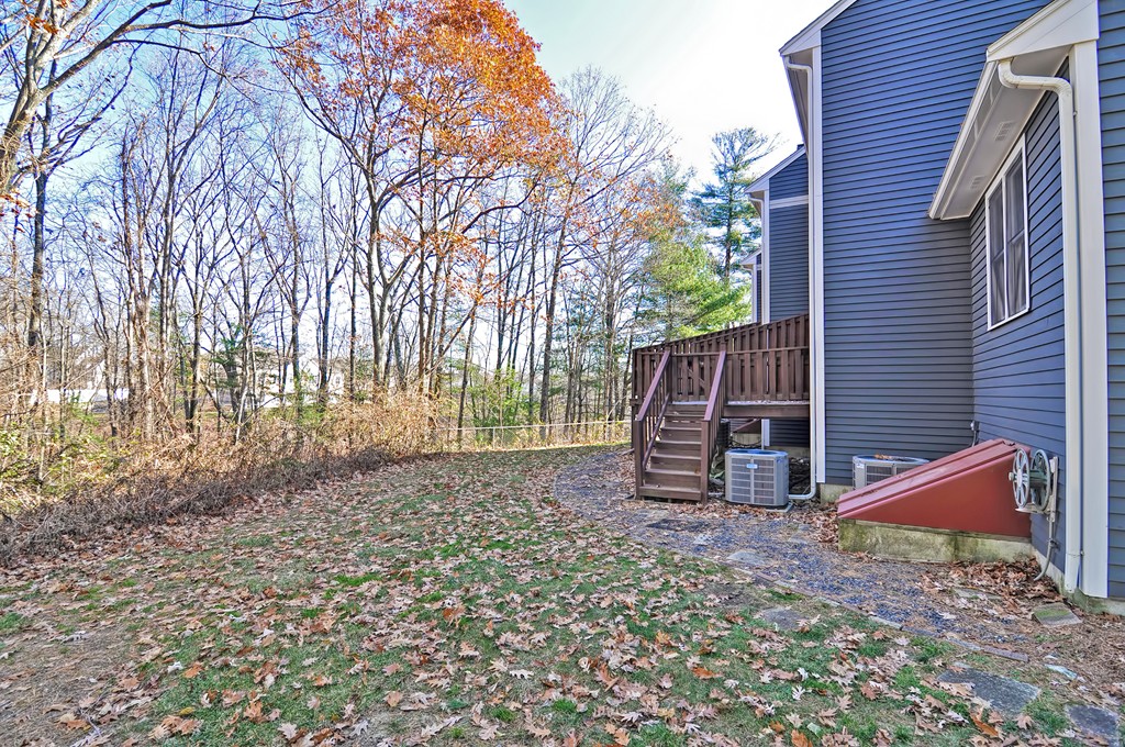 43 Stall Brook Road, Unit 43 Milford, MA 01757 - Photo 26 of 27 a view of backyard with wooden fence and large trees