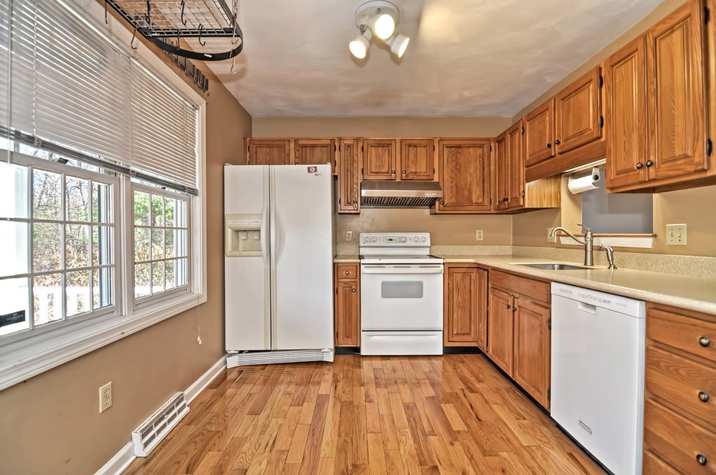 43 Stall Brook Road, Unit 43 Milford, MA 01757 - Photo 3 of 27 a kitchen with a white cabinets and white appliances