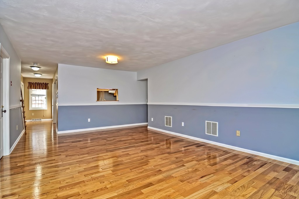 43 Stall Brook Road, Unit 43 Milford, MA 01757 - Photo 9 of 27 a view of an empty room with window and wooden floor