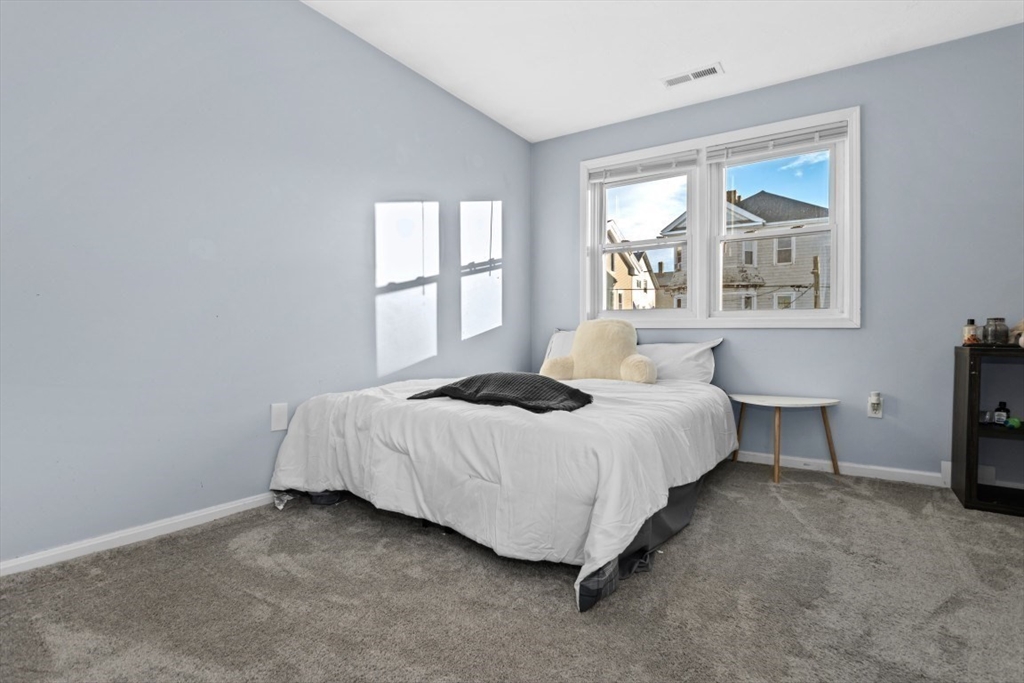 9 Doctor Street Fall River, MA 02720 - Photo 7 of 14 a bedroom with a bed painting and a window