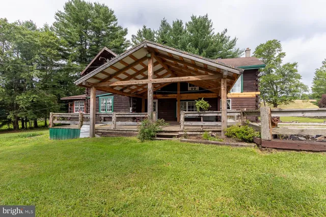 a view of a house with a yard and sitting area